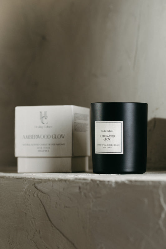 Amberwood Glow candle in black glass vessel by Healing Culture — soy and beeswax blend with amber and sandalwood.